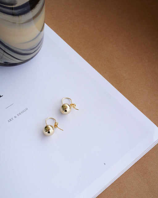 Close-up of Iris Droplet Earring – polished 18K gold-filled finish with soft, curved silhouette