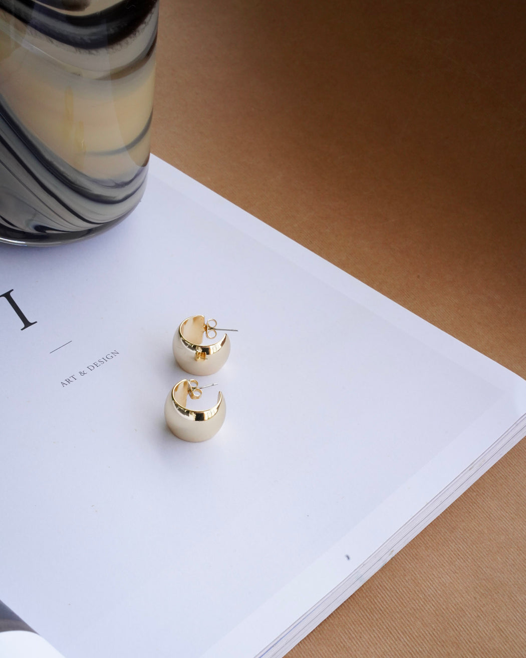 Close-up side view of Gia bold gold hoop earrings