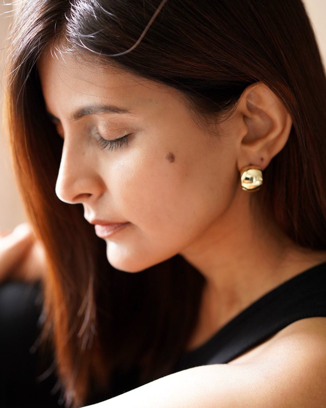 Sculpted textured hoop earrings styled with minimalist outfit