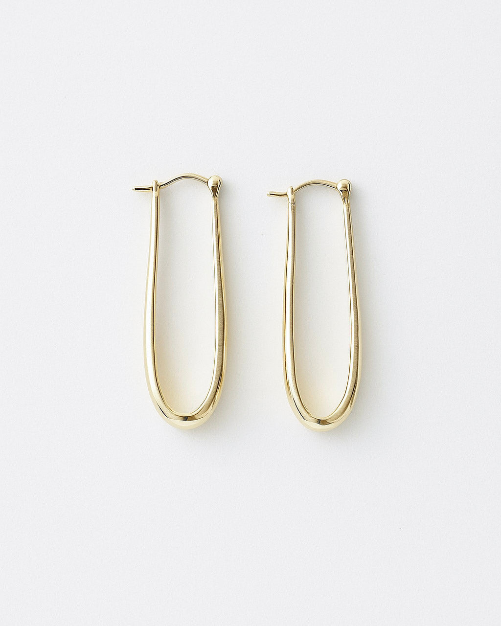 Close-up of Layla gold-filled statement hoops with high-polish finish