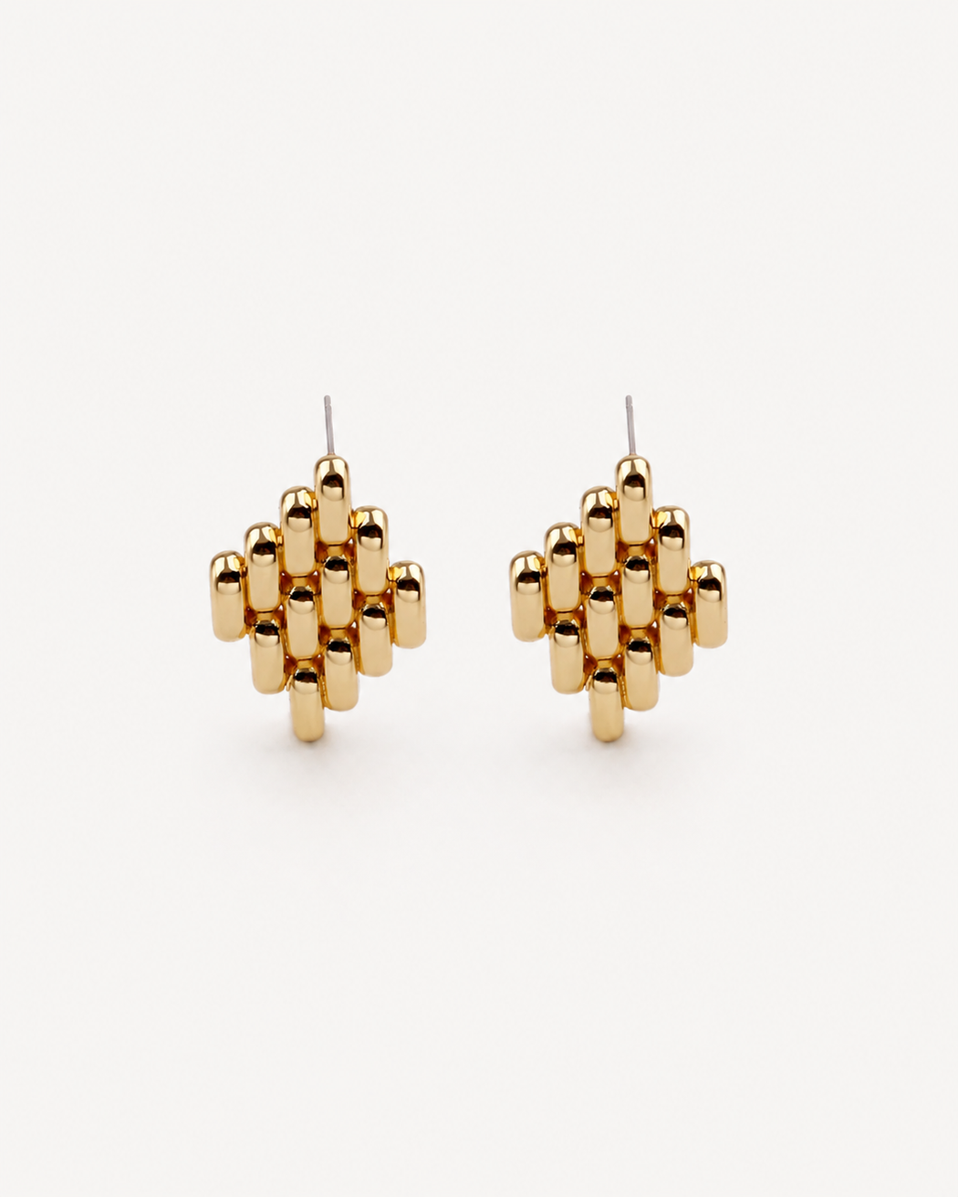 Gold geometric earrings on a white background