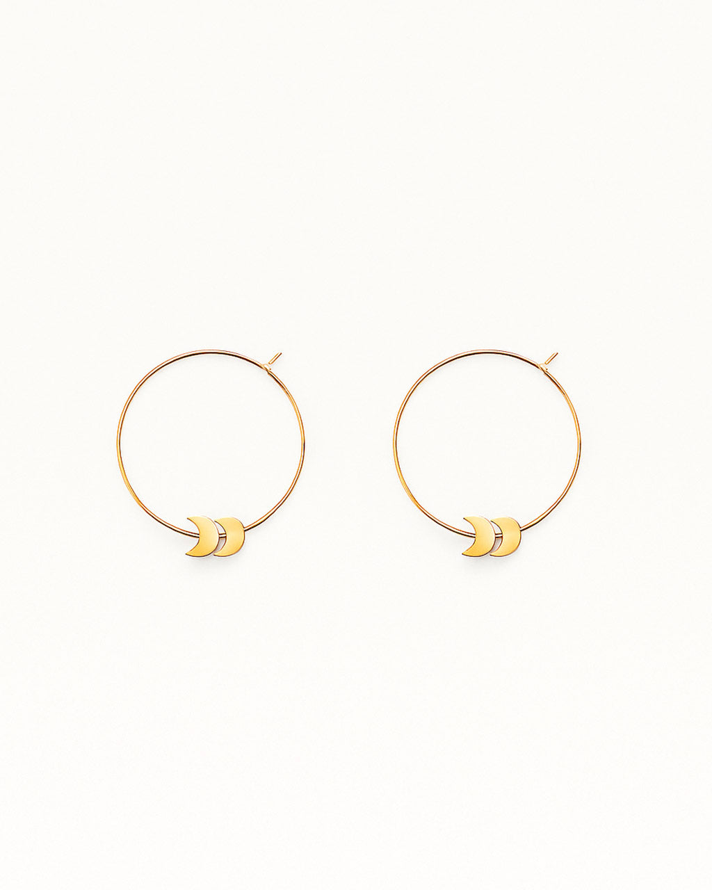 Freya gold hoop earrings in 24K gold-plated brass on white background