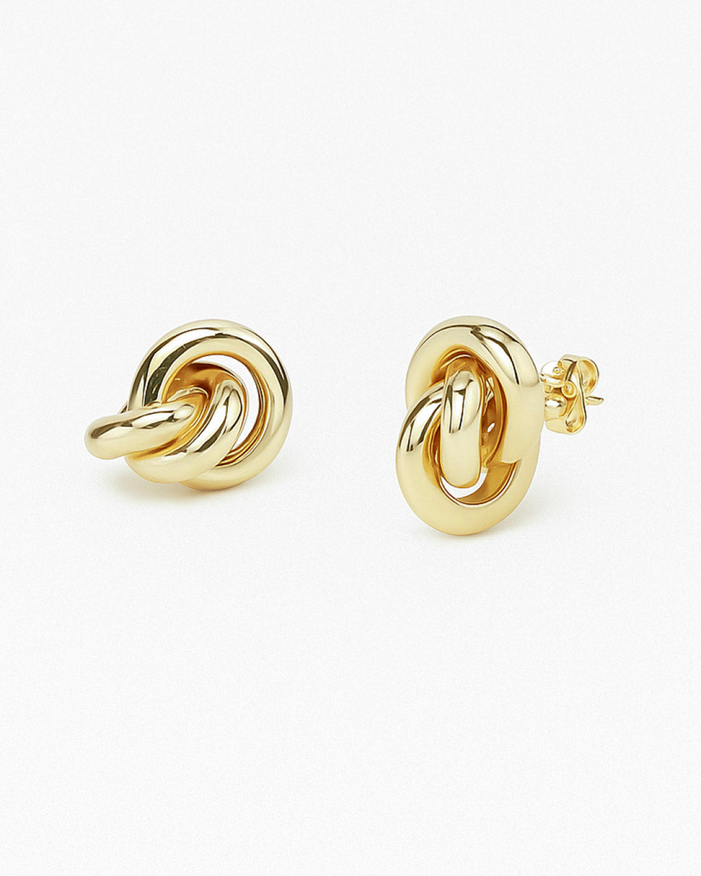 Mara sculptural gold earring photographed on white background