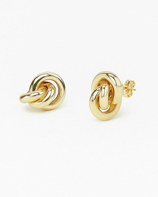 Mara sculptural gold earring photographed on white background