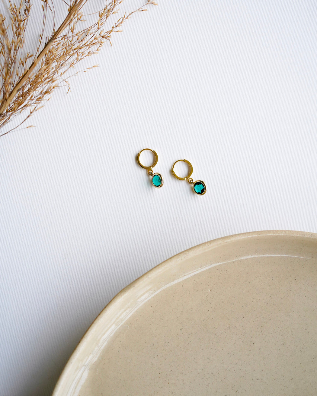 April gold drop earrings flat lay