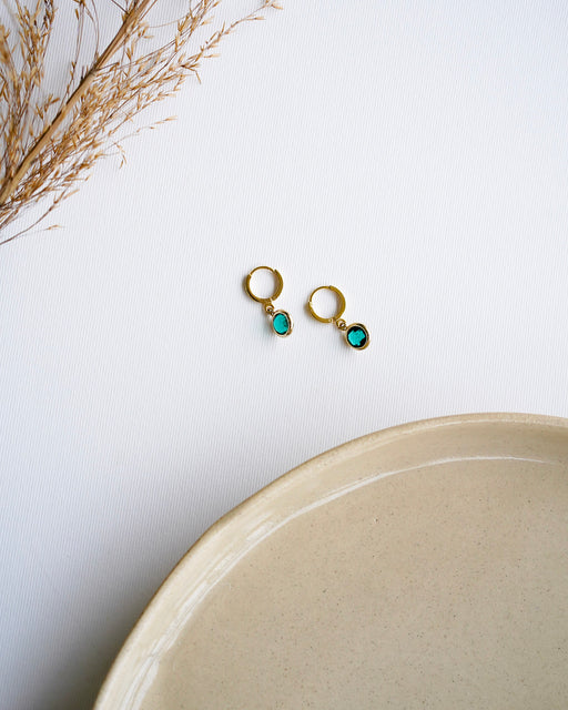 April gold drop earrings flat lay
